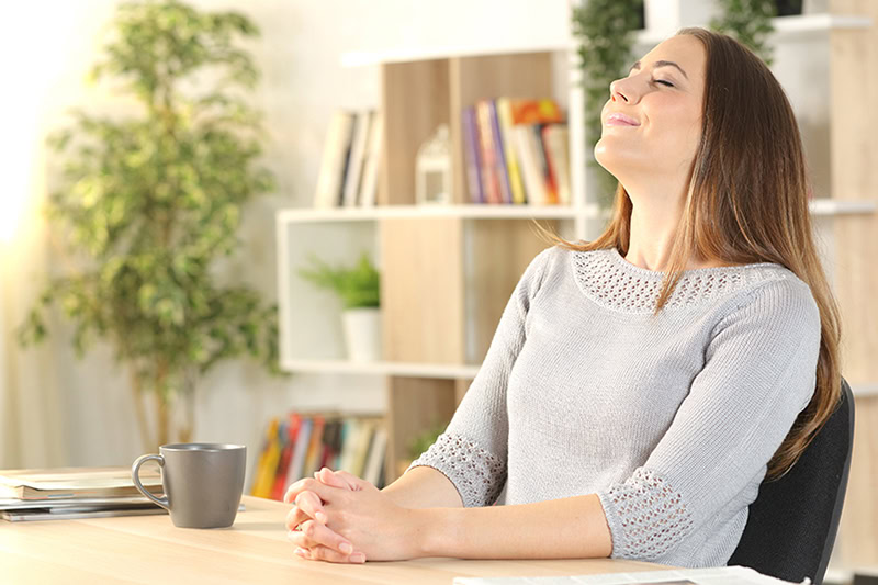 Maintaining the Best Humidity Level in a Oregon Winter. A woman sitting in her warm, clean house.